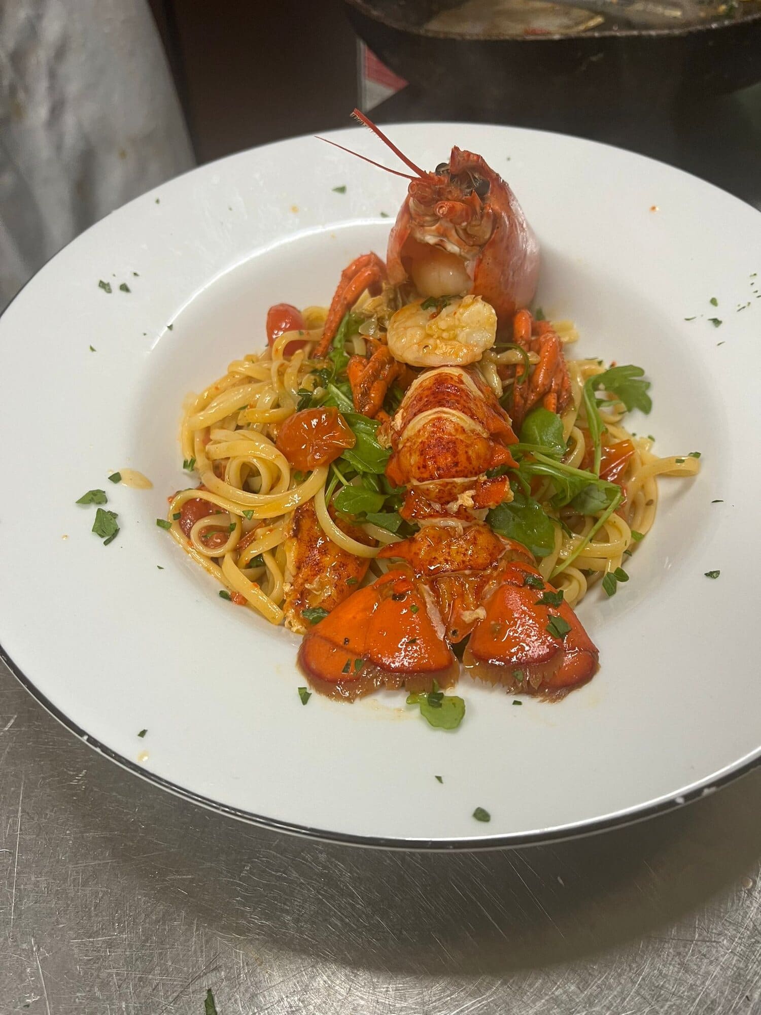 Lobster served on a bowl of linguine with prawns, cherry tomatoes, rocket and parsley at Fabio's Italian Restaurant in Swindon